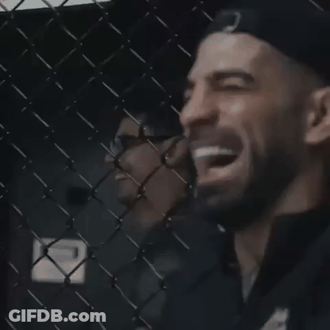 Man Laughing Behind Chain Link Fence GIF