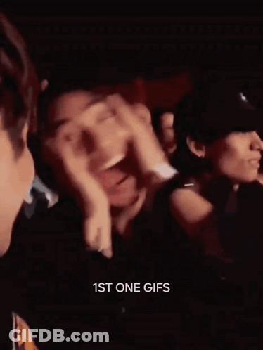 Man Laughing Hand On Face In Crowd GIF