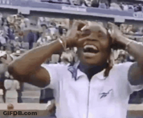 Man Laughing Hands On Head In Crowd At Tennis Match GIF