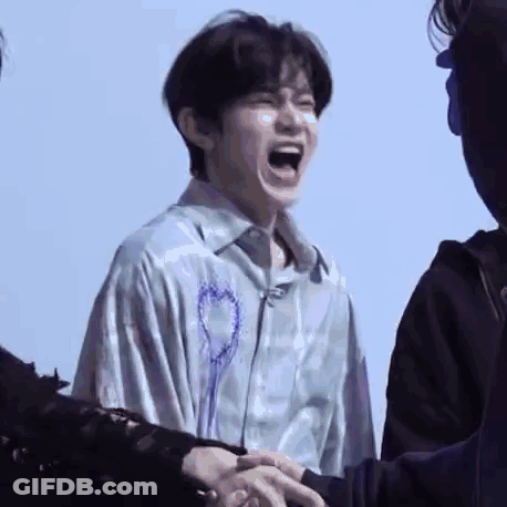 Man Laughing Holding Another's Hand GIF