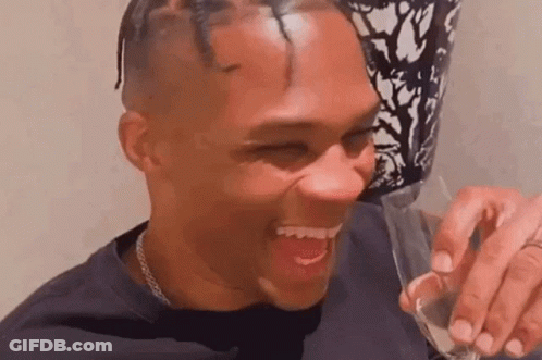 Man Laughing Holding Glass Of Wine GIF