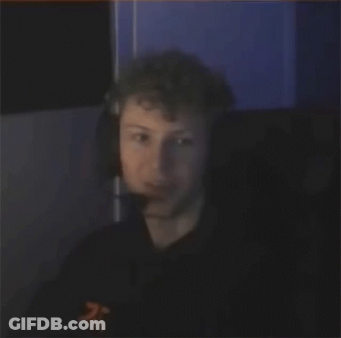 Man Laughing In Dark Room With Headphones GIF