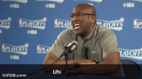Man Laughing In Front Of NBA Playoffs Sign GIF
