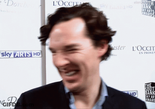 Man Laughing In Front Of Sky Arts HD Sign GIF