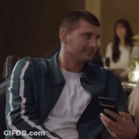 Man Laughing Looking At Phone GIF