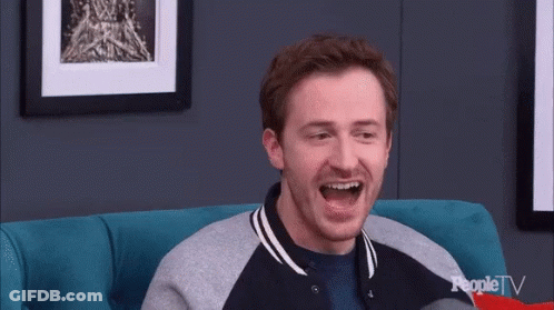 Man Laughing On Blue Couch With Peopletv GIF