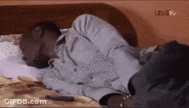 Man Laying Head On Another Man's Stomach GIF