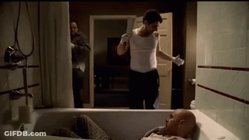 Man Laying In Bathtub Holding Knife GIF