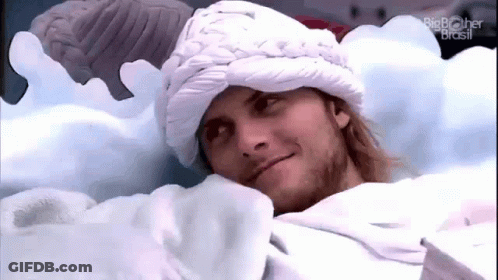 Man Laying In Bed Wearing White Hat GIF