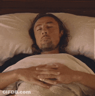 Man Laying In Bed With Eyes Closed And Hands On Chest GIF