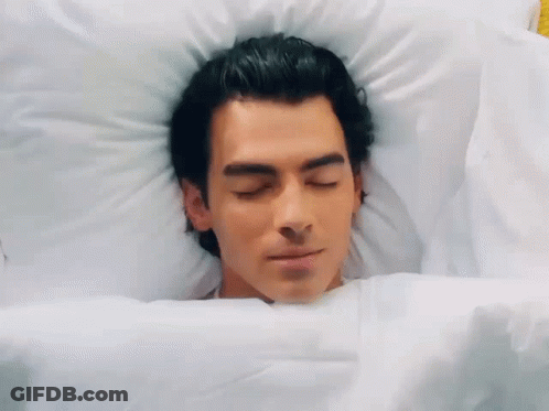 Man Laying In Bed With Eyes Closed GIF