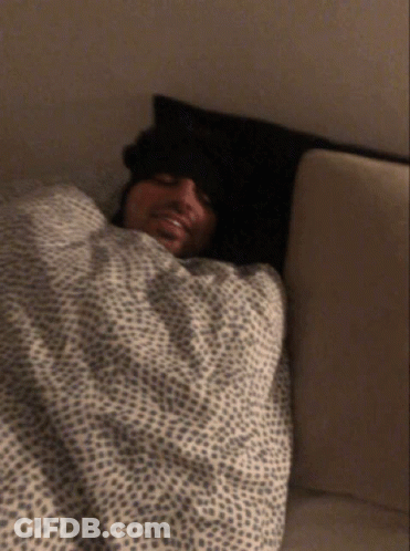 Man Laying In Bed With Leopard Print Blanket GIF