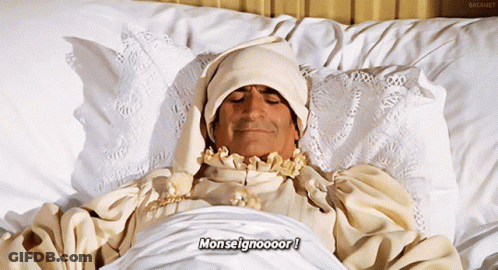 Man Laying In Bed With Word Monseigneur GIF