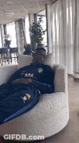 Man Laying In Chair With Adidas Shirt GIF