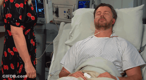 Man Laying In Hospital Bed With Monitor Saying 96 GIF