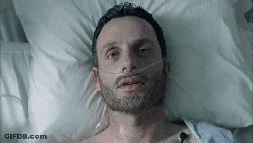Man Laying In Hospital Bed With Oxygen Mask GIF