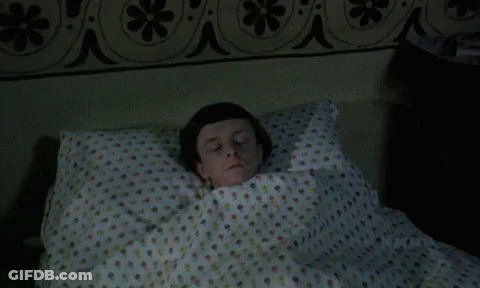 Man Laying In Polka Dot Bed GIF