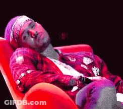 Man Laying In Red Chair With Bandana GIF