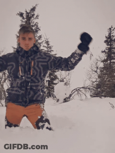 Man Laying In Snow With Arms Up GIF