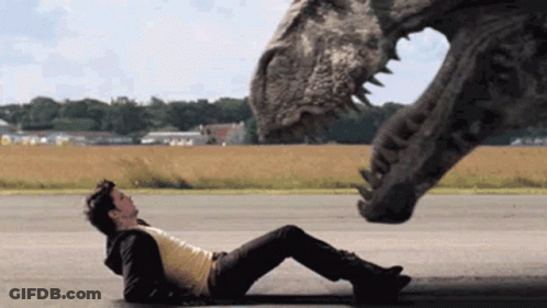 Man Laying Next To Dinosaur GIF