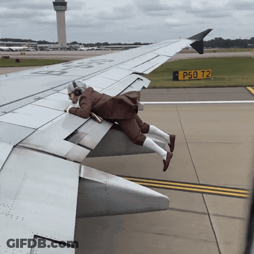 Man Laying On Airplane Wing With P50 T2 Sign GIF
