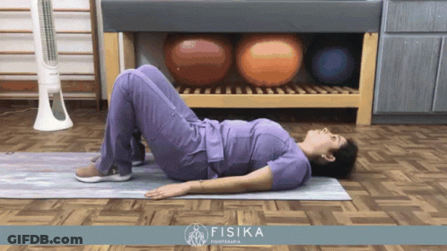 Man Laying On Another Man's Back In Iron Clad Gym GIF