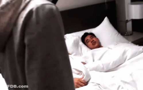 Man Laying On Bed Looking At Another Man GIF
