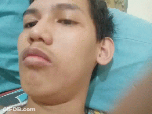 Man Laying On Bed Making Funny Face GIF