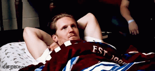 Man Laying On Bed With Est 1999 Shirt GIF