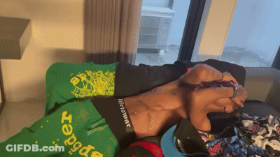 Man Laying On Bed With Green Blanket Saying Brasil GIF