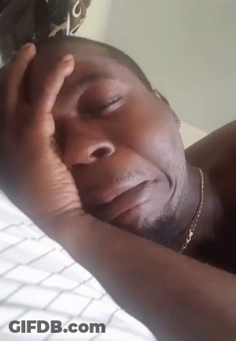 Man Laying On Bed With Hand On Head GIF