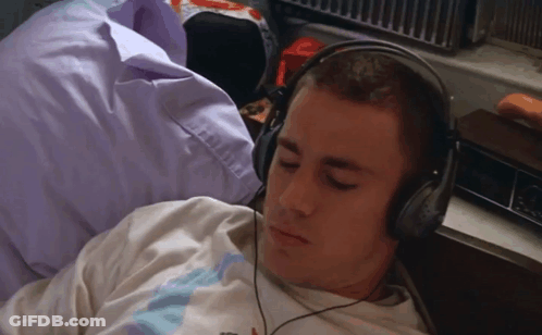 Man Laying On Bed With Headphones GIF