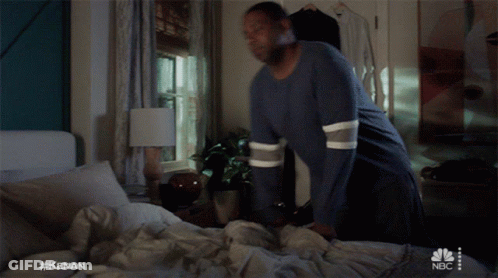 Man Laying On Bed With NBC Logo GIF