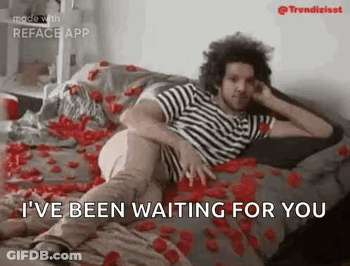 Man Laying On Bed With Roses GIF
