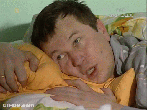 Man Laying On Bed With Seriale GIF