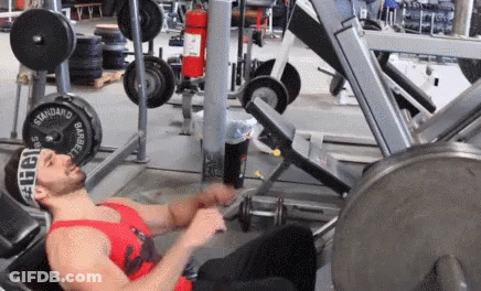 Man Laying On Bench In Red Tank Top GIF