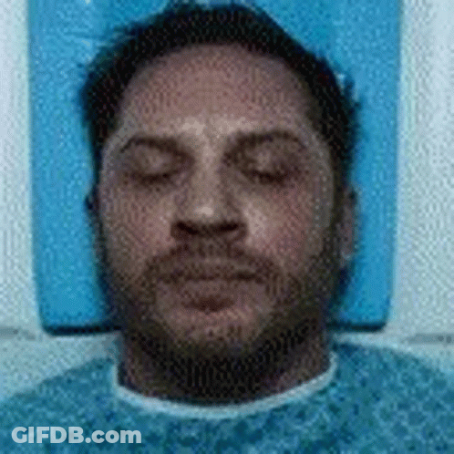 Man Laying On Blue Cushion With Eyes Closed GIF