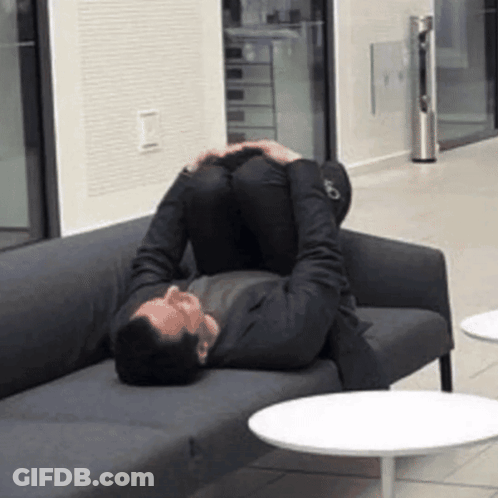 Man Laying On Couch Feet Up GIF