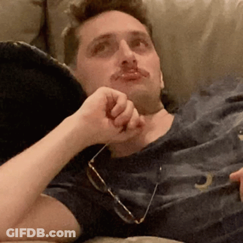 Man Laying On Couch In Glasses And Letter O Shirt GIF