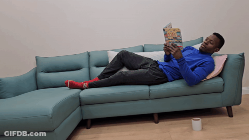 Man Laying On Couch Reading Book GIF