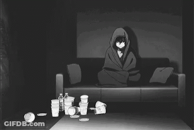 Man Laying On Couch Surrounded By Trash In Dark Room GIF