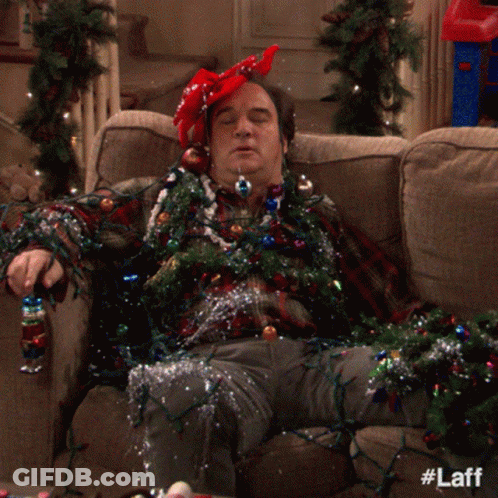 Man Laying On Couch With Christmas Lights GIF
