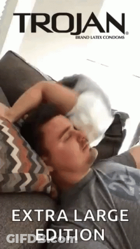 Man Laying On Couch With Trojan Condom On Head GIF