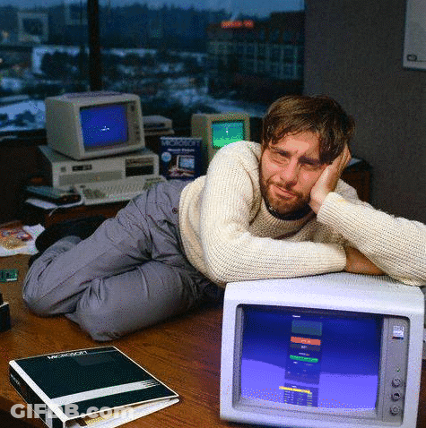 Man Laying On Desk With Microsoft Binder GIF