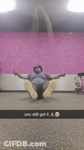 Man Laying On Floor By Pink Wall With Circles GIF