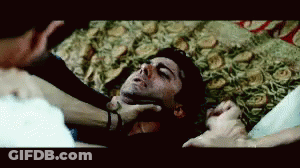 Man Laying On Floor With Eyes Closed Being Held By Neck GIF