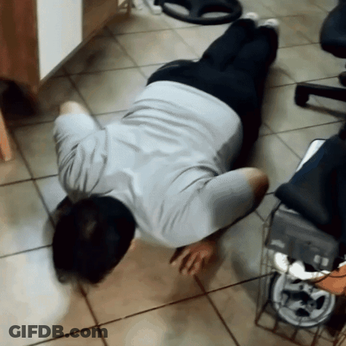 Man Laying On Floor With Head On Knees GIF