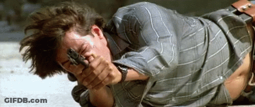 Man Laying On Ground Holding Gun GIF