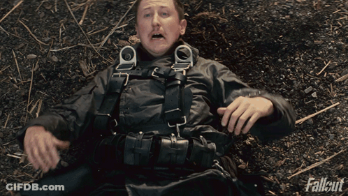 Man Laying On Ground With Fallout GIF
