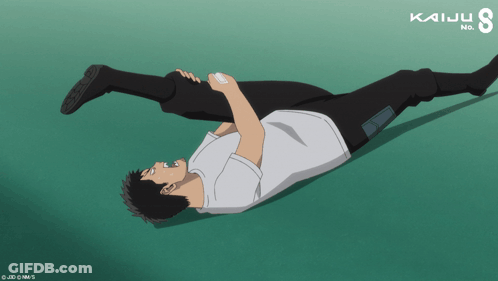 Man Laying On Ground With Kaiju Text GIF